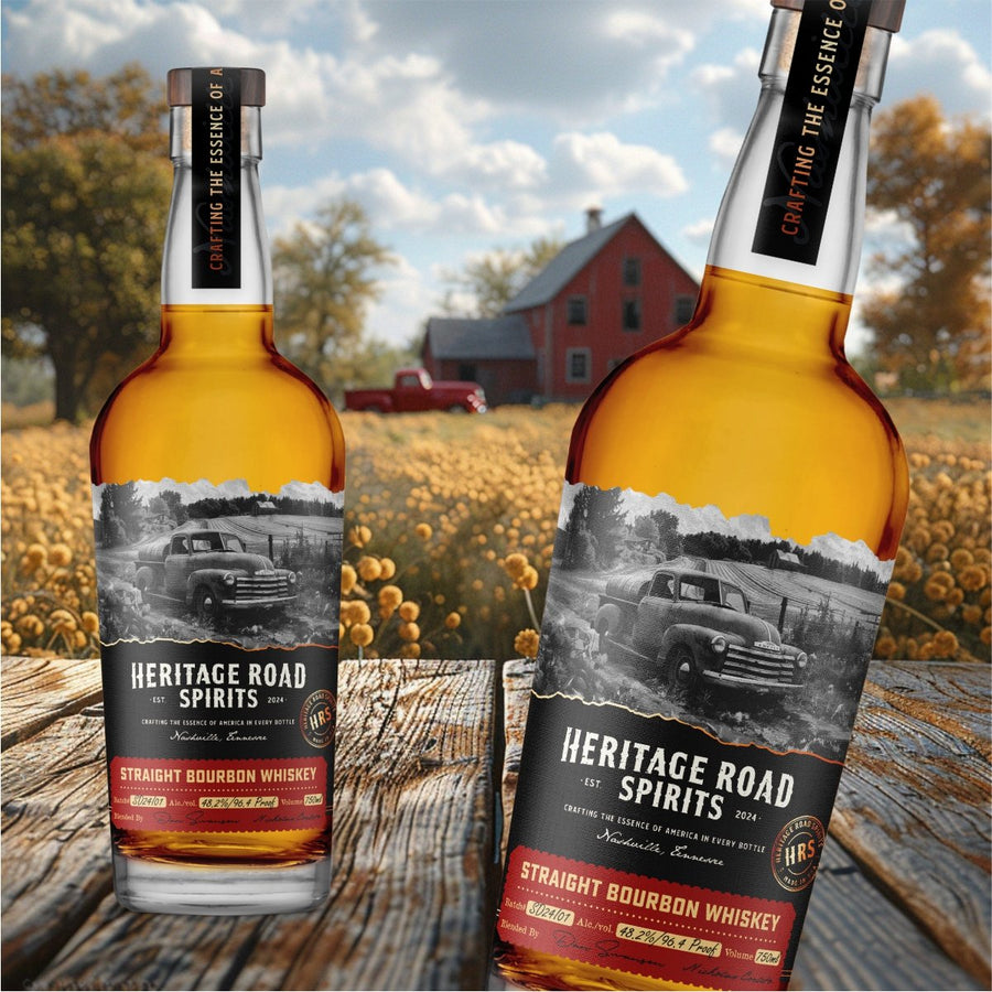 Heritage Road Spirits Straight Bourbon Whiskey bottle on a wooden table in front of a farm field